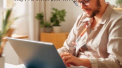 A self-employed professional working from home, reviewing health insurance plans on a laptop.